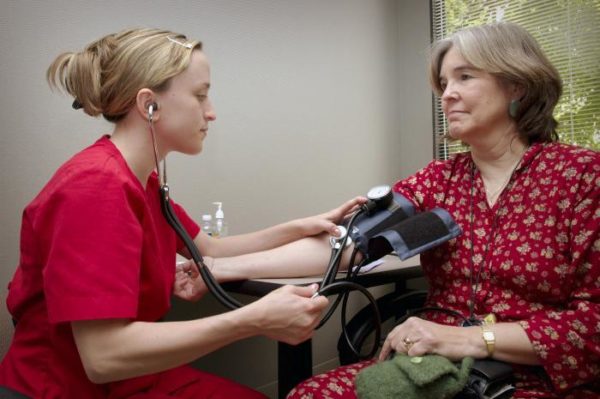 A woman has her blood pressure checked. Image credit: CDC